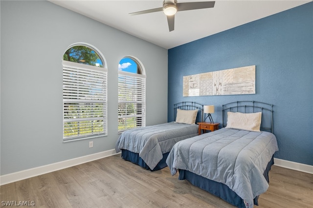 bedroom featuring wood-type flooring, ceiling fan, and lofted ceiling