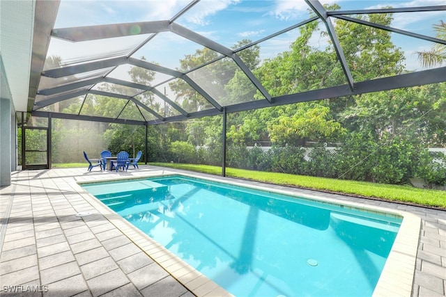 view of swimming pool with a lanai and a patio