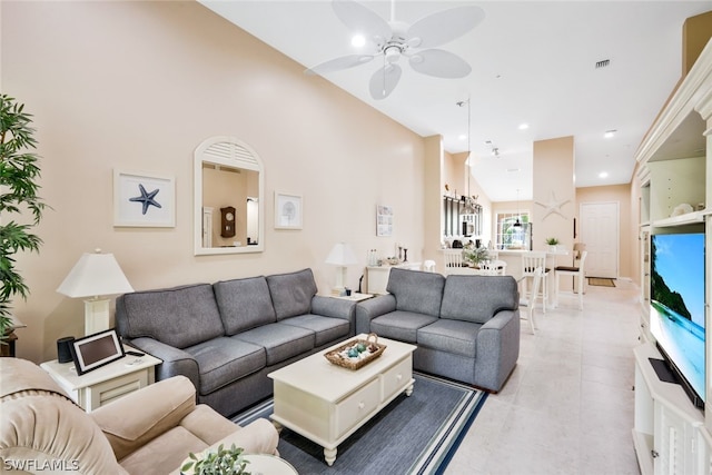 living room featuring ceiling fan and lofted ceiling