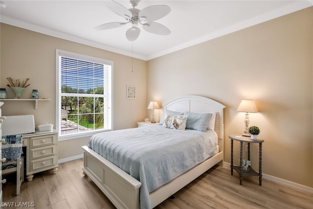 bedroom with ceiling fan, light wood-type flooring, ornamental molding, and multiple windows