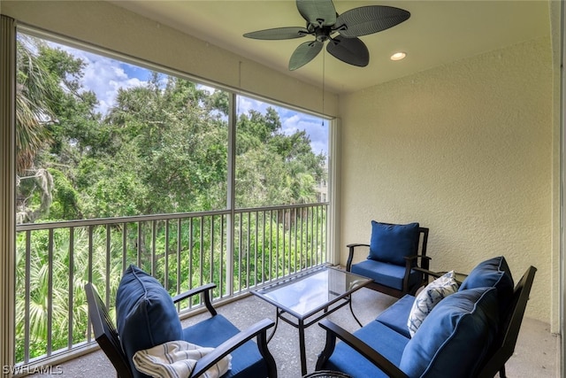 sunroom featuring ceiling fan