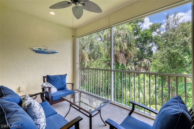 sunroom / solarium featuring a wealth of natural light and ceiling fan