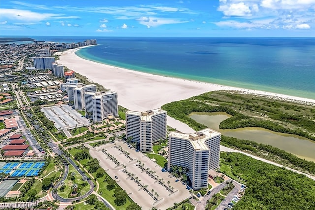 drone / aerial view with a water view and a beach view