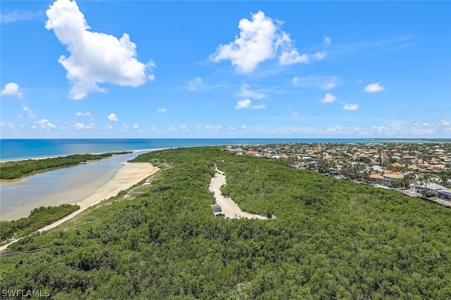 birds eye view of property with a water view and a beach view