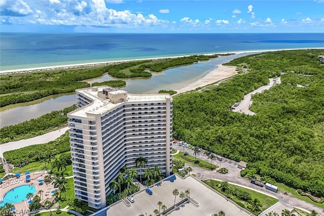 birds eye view of property with a water view and a beach view