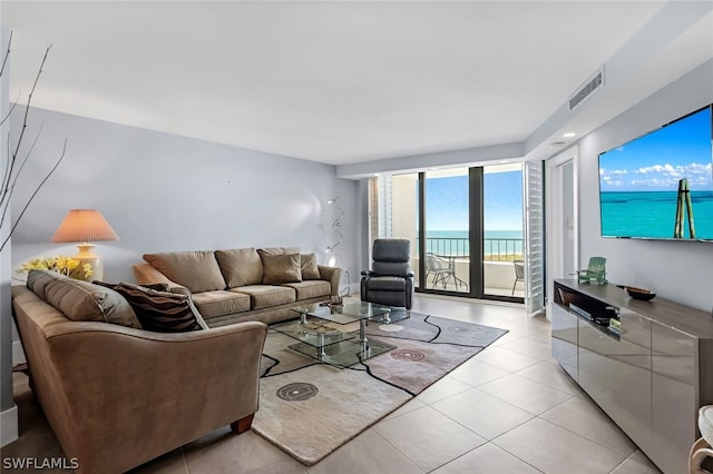 tiled living room with floor to ceiling windows