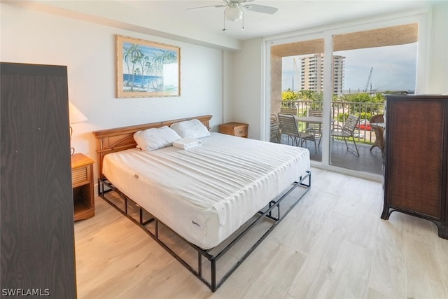 bedroom with ceiling fan, light wood-type flooring, access to exterior, and a wall of windows