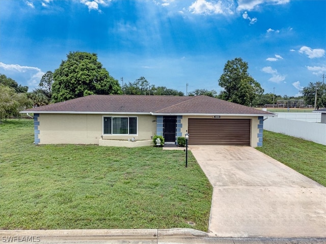 single story home with a garage and a front lawn