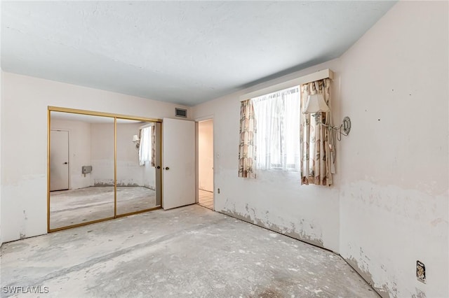 unfurnished bedroom featuring visible vents and a closet