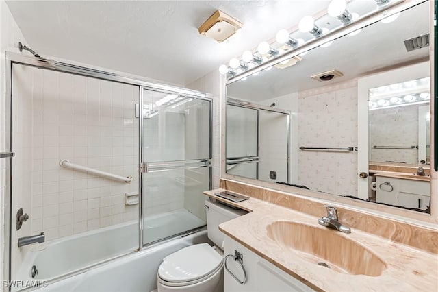 full bath featuring visible vents, shower / bath combination with glass door, vanity, and toilet