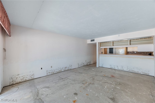 interior space featuring electric panel and concrete floors