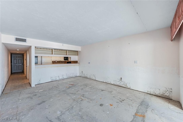 unfurnished living room featuring visible vents