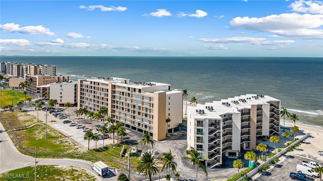 aerial view with a water view and a beach view