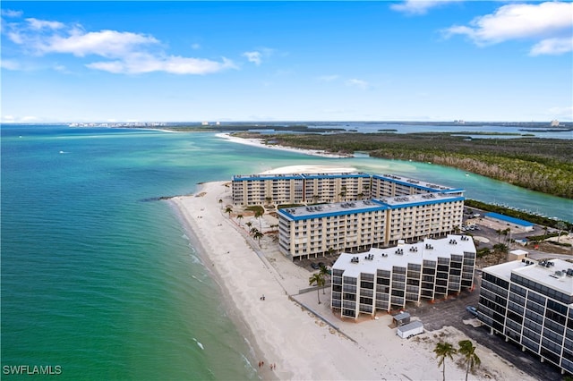 birds eye view of property featuring a water view and a beach view