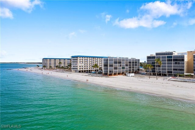 drone / aerial view featuring a water view and a beach view