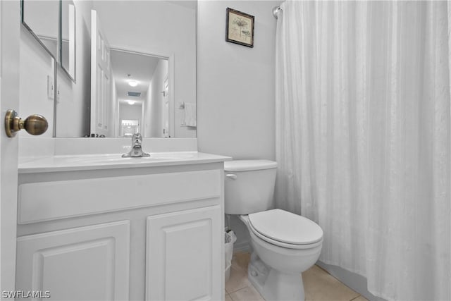 bathroom with tile patterned flooring, vanity, and toilet