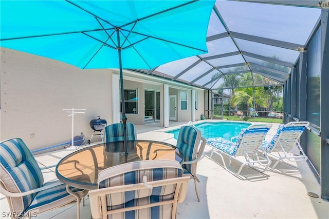 view of pool featuring a patio area and glass enclosure