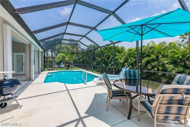 view of pool featuring a patio area and glass enclosure