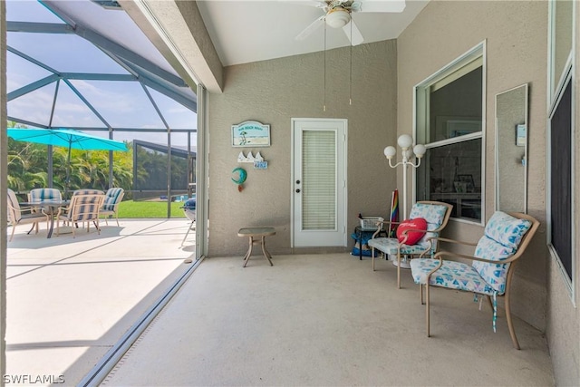 sunroom / solarium featuring lofted ceiling and ceiling fan