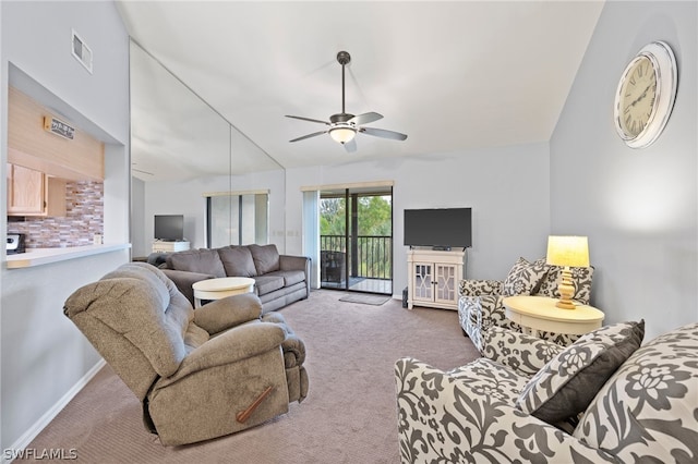 carpeted living room with vaulted ceiling and ceiling fan