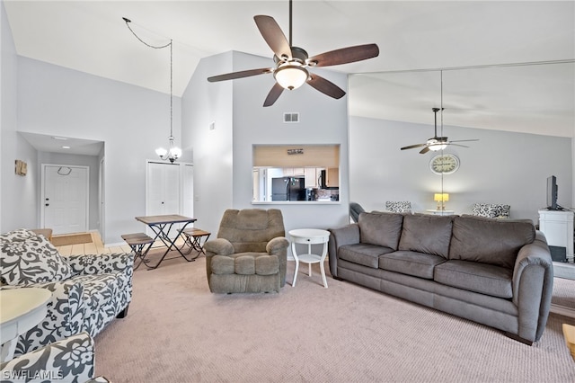 living room featuring ceiling fan with notable chandelier, carpet flooring, and high vaulted ceiling