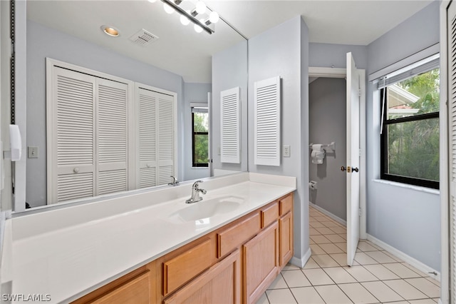 bathroom with tile patterned floors and vanity