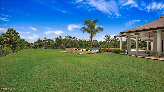 view of yard with ceiling fan and a patio