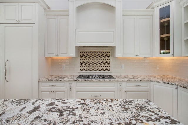 kitchen with stainless steel gas cooktop and white cabinets