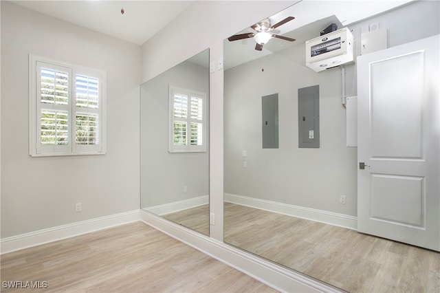 bathroom featuring a wealth of natural light, electric panel, and ceiling fan