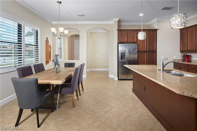 kitchen with stainless steel fridge with ice dispenser, light tile patterned floors, an inviting chandelier, light stone counters, and decorative light fixtures