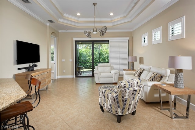 tiled living room featuring crown molding, a chandelier, and a tray ceiling