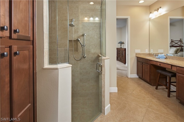 bathroom featuring vanity, an enclosed shower, and tile patterned flooring