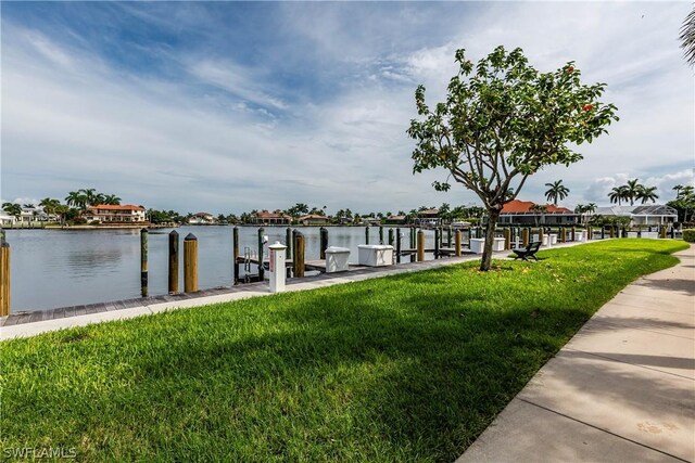 dock area featuring a water view and a lawn