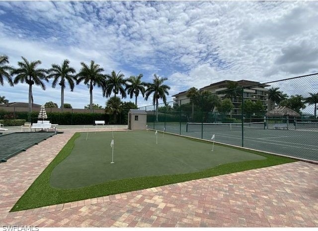 view of community featuring tennis court