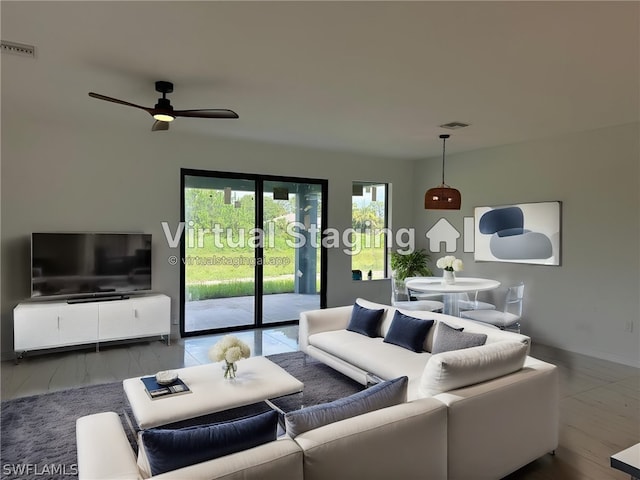 living room featuring hardwood / wood-style floors and ceiling fan