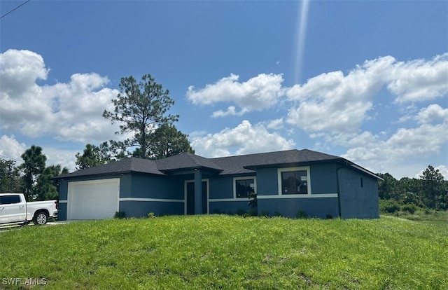 view of front of house with a front yard and a garage