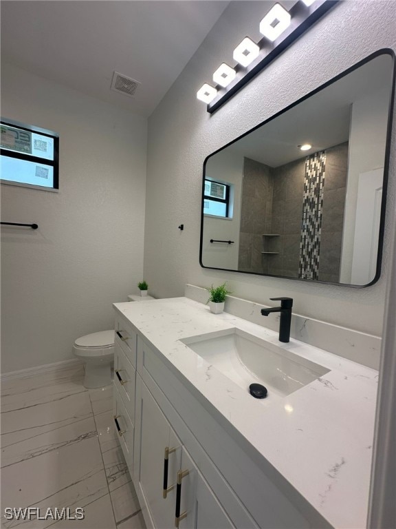 bathroom with toilet, curtained shower, and vanity