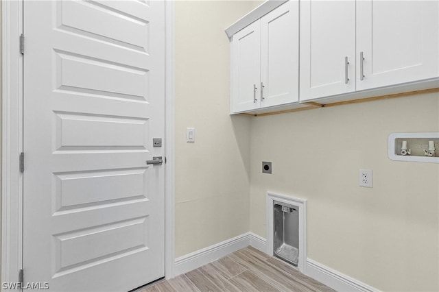 washroom featuring hookup for a washing machine, light hardwood / wood-style floors, electric dryer hookup, and cabinets