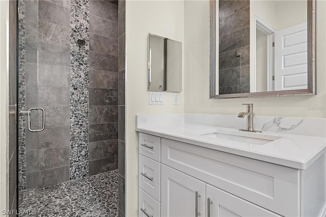 bathroom featuring walk in shower and vanity