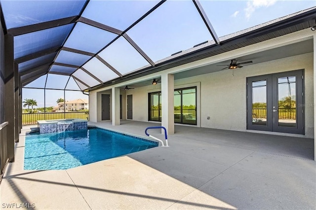 view of pool featuring an in ground hot tub, glass enclosure, a patio area, and ceiling fan