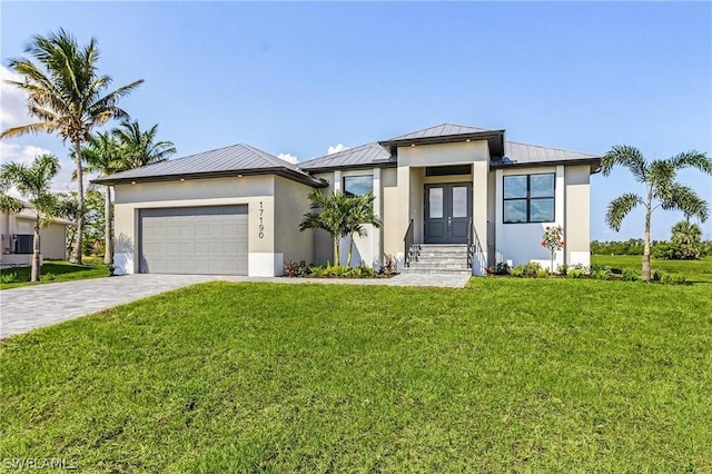 view of front of property featuring a garage and a front yard