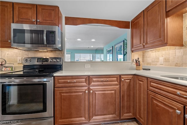 kitchen featuring decorative backsplash and appliances with stainless steel finishes