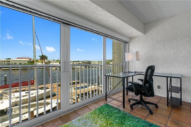 tiled office with a textured ceiling and a water view