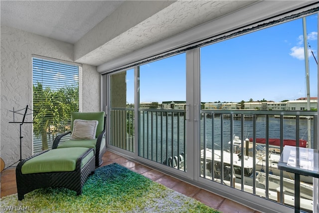 sunroom / solarium featuring a water view