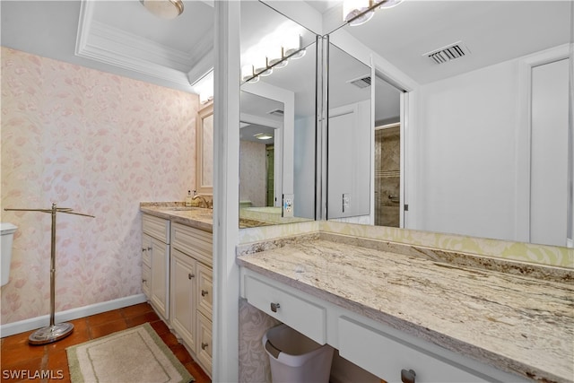 bathroom with tile patterned floors, vanity, a raised ceiling, crown molding, and toilet