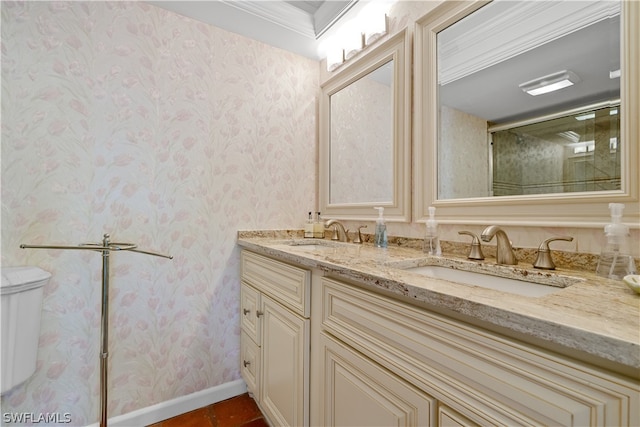 bathroom with dual bowl vanity, crown molding, and toilet