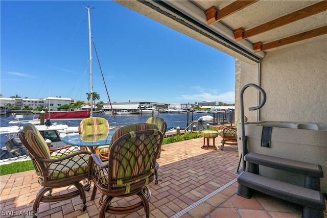 view of patio with a water view