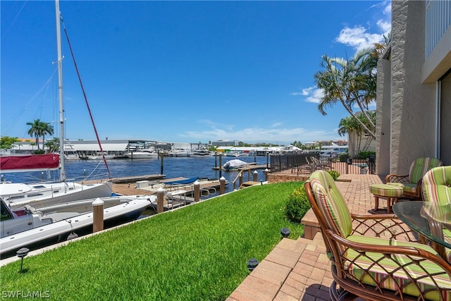 view of patio / terrace featuring a water view and a boat dock