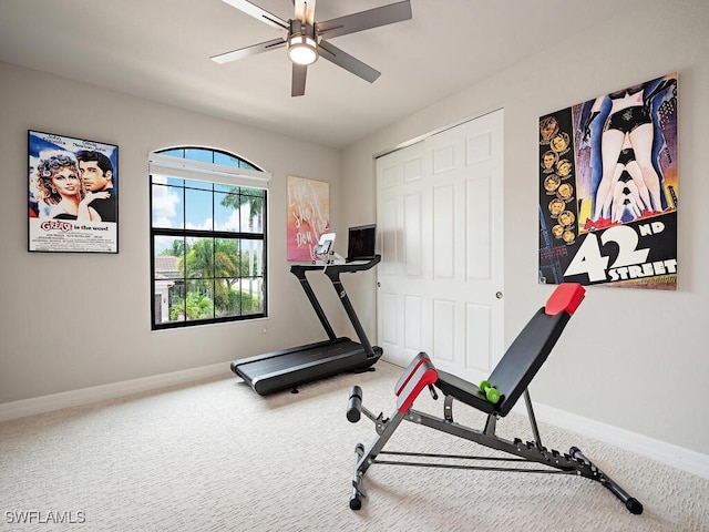 exercise room with ceiling fan and carpet