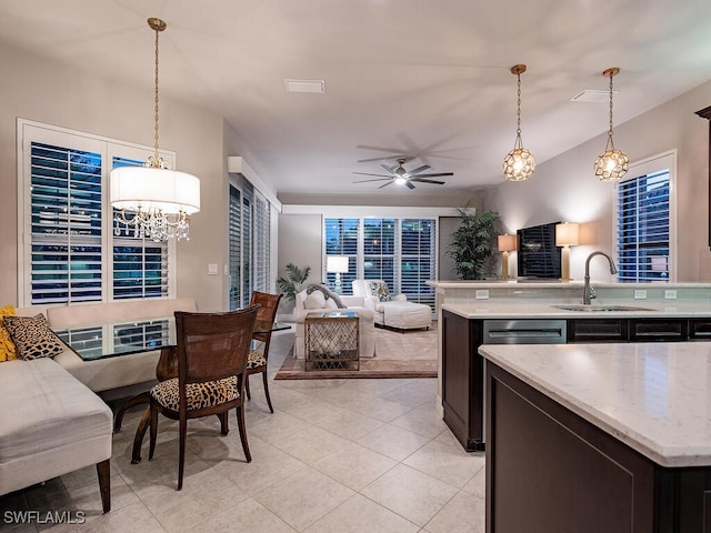 kitchen featuring sink, dark brown cabinets, pendant lighting, and ceiling fan